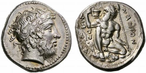 Silver tetradrachm of the polis of Naxos (Sicily).  On the obverse, a bearded head of Dionysus, wear