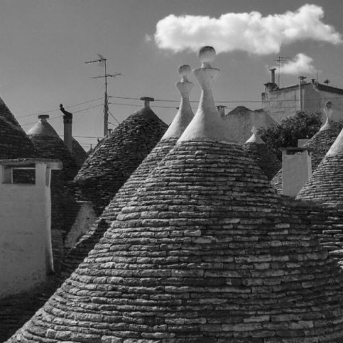 The Cone-shaped Roofs Of Alberobello's Trulli In Puglia, Italy. Derived From The Greek Word Τρούλος