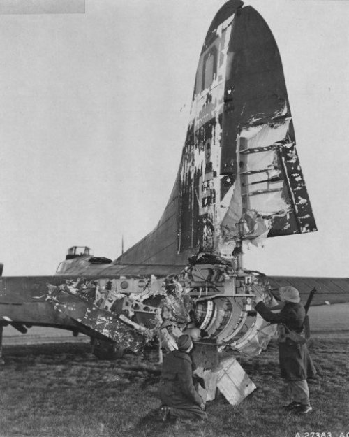 A B-17 of the 100th Bomber Squadron of the USAAF rests in an English airfield after being severely d