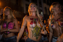 Topless and body painted at a Brazilian carnival,