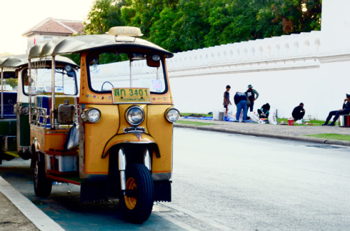 It’s a yellow tuk-tuk in Bangkok, Thailand. It’s kind of like a yellow taxi, but a tad smaller. 