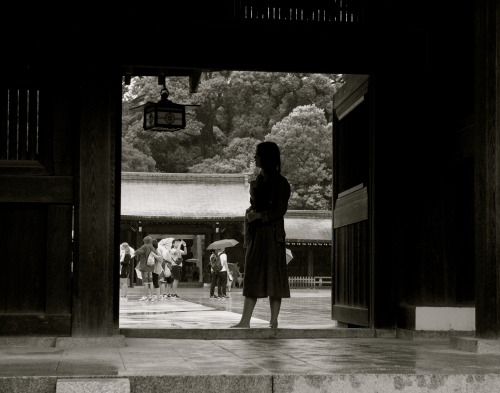 Girl standing in the entrance way at Meiji shrine, Tokyo, Japan