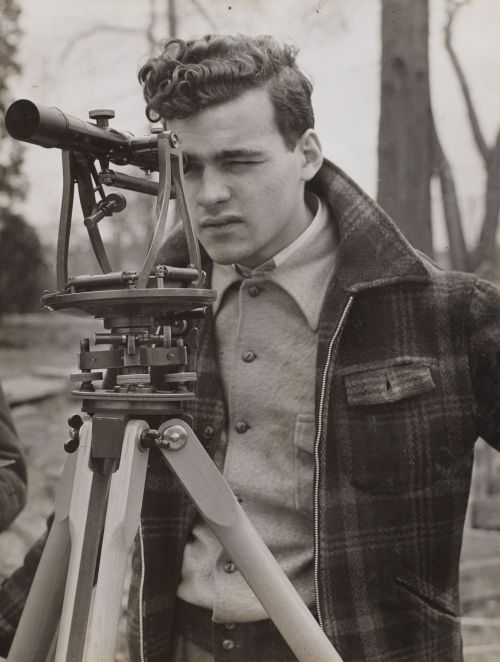 Arnold Eagle. Young man peers through a surveyor’s tool,  about 1940–1942.  