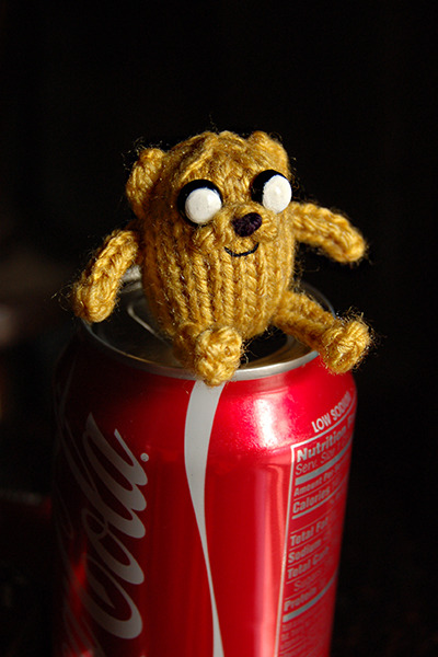 superslyskillzmcfly:  I just finished my first knitting pattern! It’s incredibly simple but I’m still pretty proud of it.  Pocket Jake! Adventure Time fans might remember the episode where Jake was mysteriously absent until the very end when he