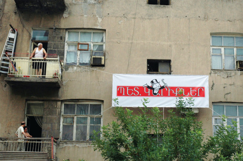 colombik:
“ At the corner of Teryan and Northern Avenue, a Soviet era building has the air of festivity adorning its façade. Flags and banners sway from wrought iron balconies in the early summer breeze. Approaching the structure, a more sobering...