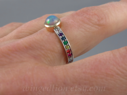 Ring in rainbow colors: Ethiopian opal, ruby, orange sapphire, yellow sapphire, emerald, blue topaz,