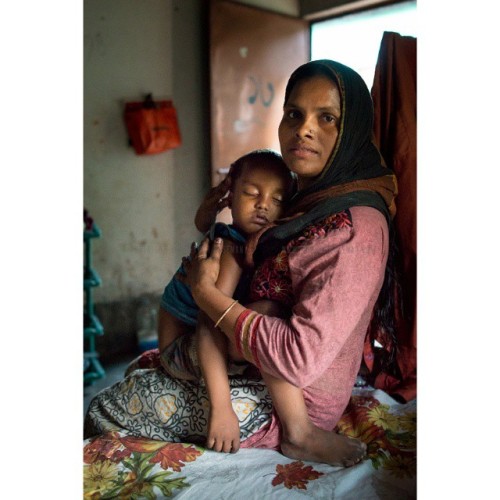 A mother embracing her sleeping son in the slums of Bangladesh. Maternal love is something most of u