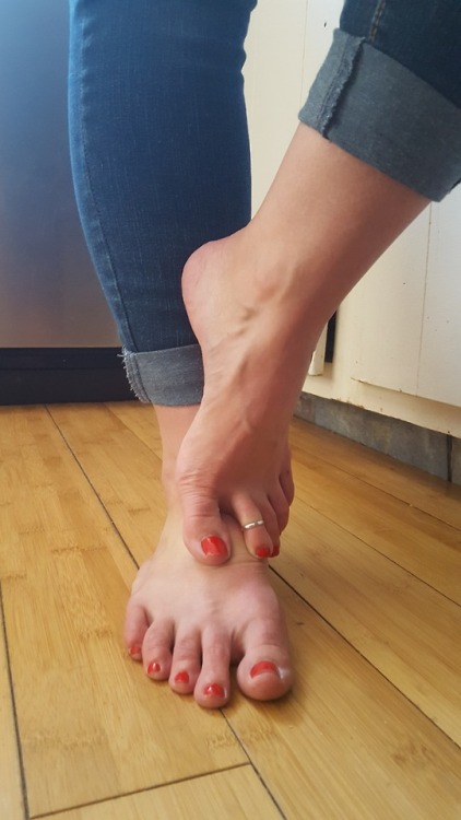 My pretty wifes beautiful candid feet on her phone.please comment