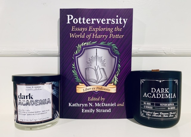 Pictured is the book Potterversity: Essays Exploring the World of Harry Potter, edited by Kathryn N. McDaniel and Emily Strand, with a purple cover framing the logo for the Potterversity academic podcast. On each side of the book are candles marked "Dark Academia."