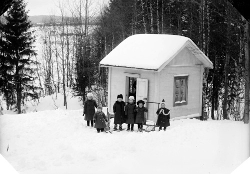 Children next to their playhouse, 1890-1910, Sweden.