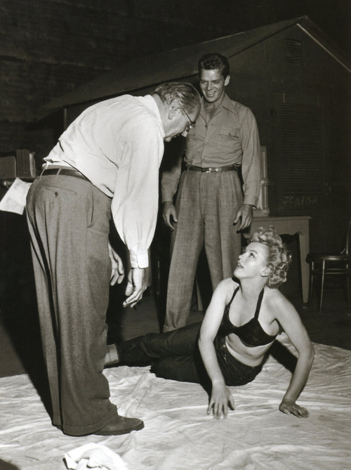 Keith Andes watches on as Fritz Lang gives direction to Marilyn Monroe on the set of Clash By Night.