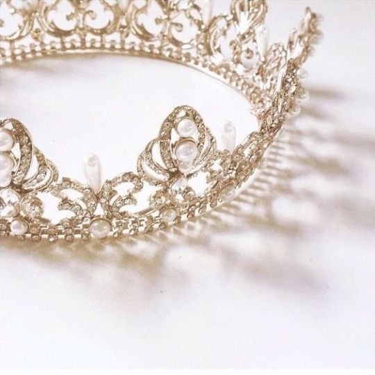 An image of a gold crown with white pearls