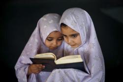 letswakeupworld:  Two Palestinian girls read the Quran during summer vacation at a mosque in Gaza City. (Photo Credit: Mohammed Salem)