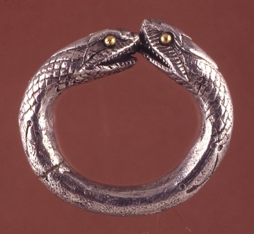 ancientpeoples:Roman Finger Ring1st Century ADSilver ring ending in snake heads with gold eyes.Sourc