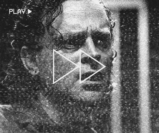 gif 4 of 6. Boggs grabs the piece of cloth and has an episode of great angst while holding it, saying a few things. it's like he's having a vision of someone's suffering by touching the cloth. the gif is very fast and skip frames; it's also very long because it's compressing a very long scene. there's old TV static, a symbol of fast-forward and the word 'play' is also in the gif, mimicking a VHS tape in fast-forward mode. the gif is in black and white, unlike the rest except for the last one.