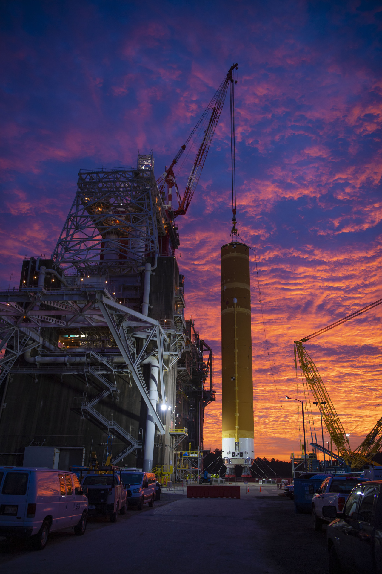 A sunrise illuminates the 212-foot-tall core stage of the SLS rocket as it is installed into the test stand.