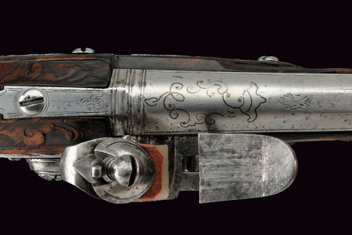 An ornate silver mounted flintlock pistol crafted by G.M. Logia, Brescia, Italy, mid 18th century.