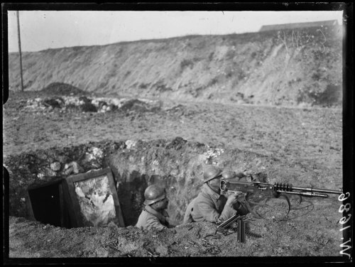 scrapironflotilla:A French machine gun crew on lookout in a camouflaged shell hole, near Chalons-sur