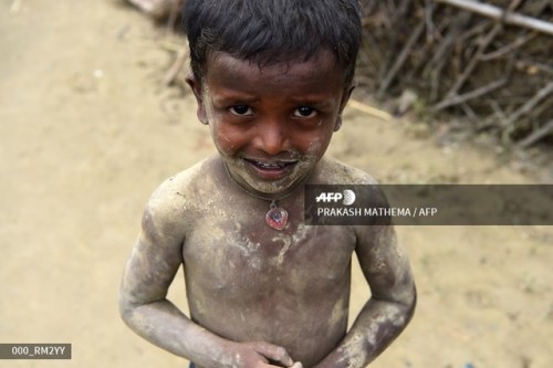  A Nepali boy whose body is covered with mud looks on in his village on the outskirts of Biratnagar 