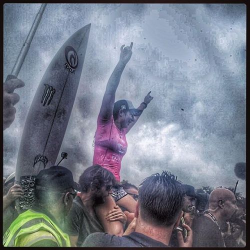 under mostly rainy skies Tyler Wright takes the 2016 Roxy Pro crown and is carried above the huge cr