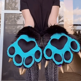 black and blue cuffs with black paw pads and gold claws. the person wearing claps and then does jazz hands
