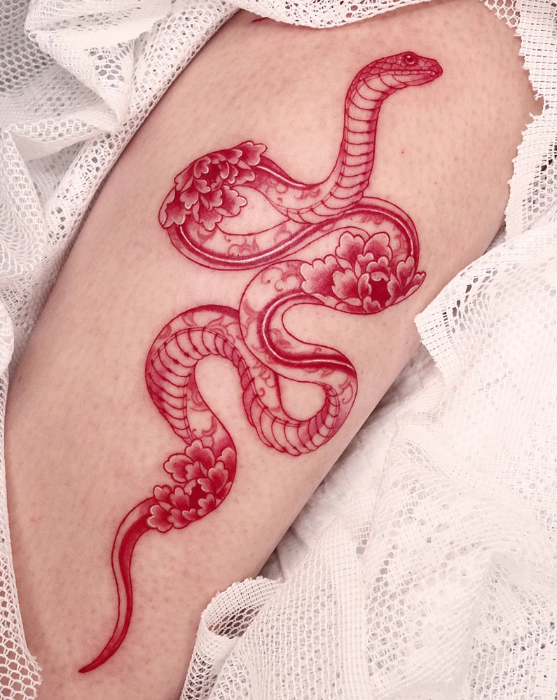 Fine line red snake tattoo on the foot