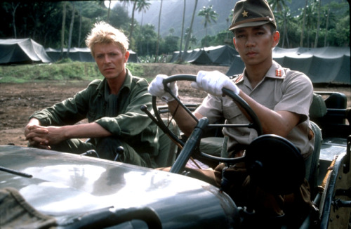 carsthatnevermadeit:David Bowie and Ryuichi Sakamoto in a Jeep in the 1983 movie Merry Christmas Mr 