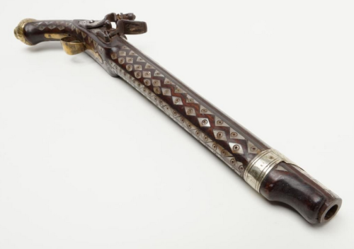 Ornate pearl and brass mounted flintlock pistol originating from North Africa, 19th century.