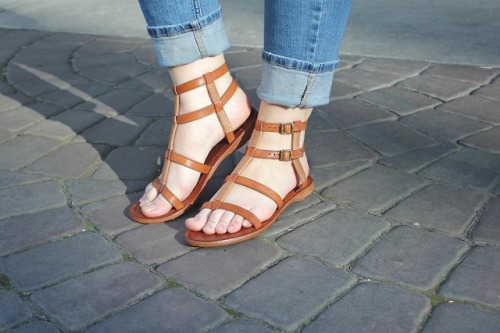 Leather gladiator sandals on pretty feet.