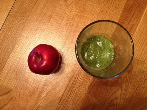 green smoothie of banana kale and apple & an intact apple for breakfast.