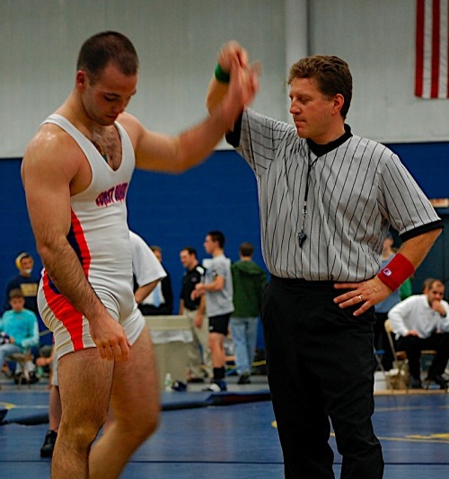 referee checking out the wrestler’s singlet bulge