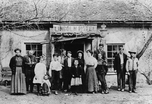Group in front of Lincoln Hotel, Lincoln, New MexicoDate: 1890 - 1900?Negative Number: 110991