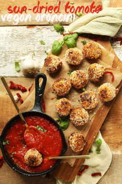 veganfoody:  Sun Dried Tomato Basil AranciniArancini is an Italian dish consisting of rice balls stuffed with “cheese”, coated in bread crumbs, and deep fried. The result is a crispy, savory ball of goodness with a cheesy center, perfect for dipping