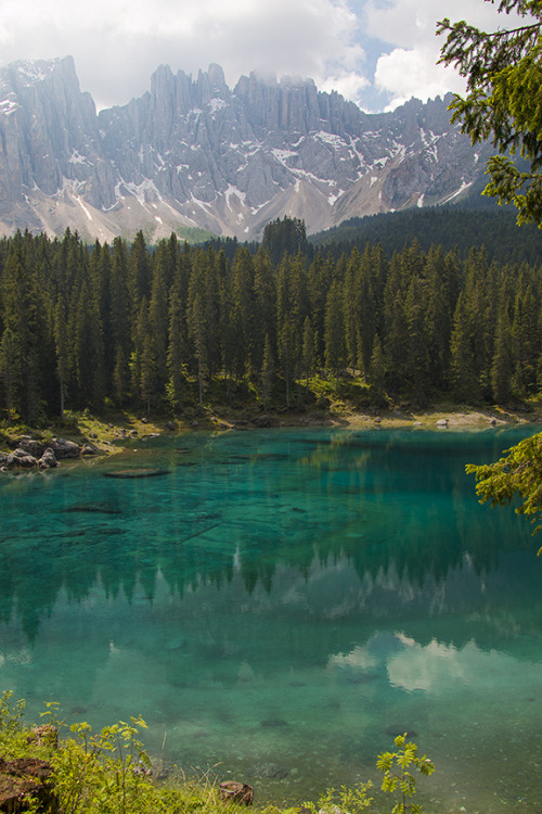 Lago di Carezza in Italian, Karersee in German, and Carezza Lake in English.