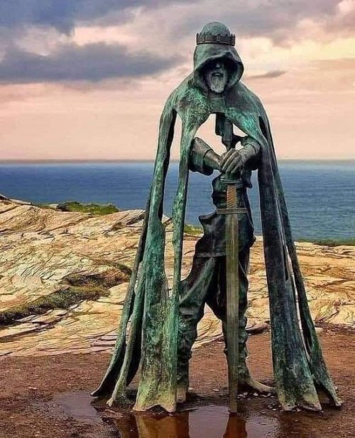 A Bronze Sculpture Of King Arthur In Tintagel Castle, Located On Peninsula Of Tintagel Island Adjacent
