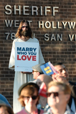 enjoyexhibitionists:  equalityabovehate:  Kevin Lee Light, known as the West Hollywood Jesus, holds a sign as he celebrates the US Supreme Court ruling during a community rally on June 26, 2013, in West Hollywood.   Now it’s time for some posts that