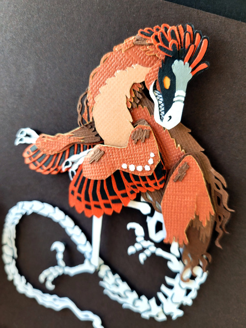 catadromously:curlicuecal:Halloween papercraft of this gorgeous artwork by @catadromously. I love the idea of chickens holding a seance and accidentally summoning their dinosaur ancestor.Have to confess, I got an hour into those little feather and bone