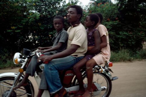 ukpuru:A group on a motorcycle going to Calabar in Eastern Nigeria shot by Peter Marlow, 1982.