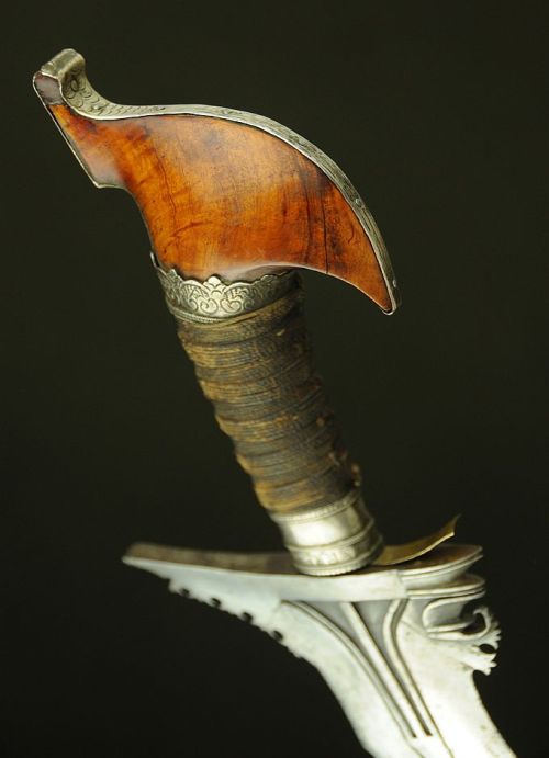 art-of-swords:  Moro Keris Sword Dated: 19th century Culture: Indonesian Measurements: overall length 29.25 inches (74.3cm); blade length 22.75 inches (57.8cm) The pommel of the sword is 4.5 inches from tip to top and is decorated with engraved silver