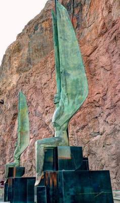 anyskin:Hoover Dam Angel - Two 30-foot tall bronze sculptures by Oskar Hansen at Hoover Dam are an unusual depiction of male angels. They are part of Hansen’s work to memorialize the workers killed during the construction of the dam. “Winged Figures of the Republic” were each formed in a continuous pour. To put such large bronzes into place without marring the highly polished bronze surface, they were placed on ice and guided into position as the ice melted.