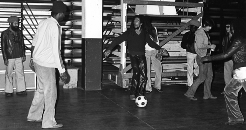 Rare photographs of Bob Marley being interviewed and playing football with friends backstage at the 