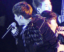 donghae picks henry up while singing blue tomorrow.    