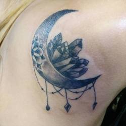 A recent tattoo of a moon and crystals and