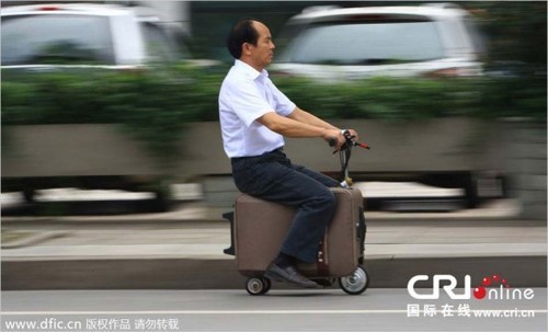 A Chinese man annoyed of carrying his suitcase converted it into a drivable scooter-suitcase.