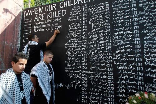 standwithpalestine:
“ A boy writes the names of Palestinian children killed by Israel since the start of their latest assault on Gaza, during a demonstration in Aida Refugee Camp near Bethlehem. (Photo: Musa Al-Shaer via SMPalestine)
”