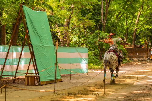 The riders are fully dressed as samurai warriors during the Yabusame Shinji. They wear a costume com