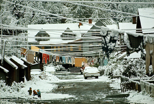 Snow hides begrimed houses, laundry, and slag in coal mining town in British Columbia, 1966.Photogra