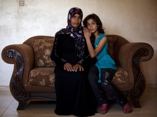 Palestinian woman Sahar Kabaha, 33, sits beside her 10-year-old daughter Nashwa, in the Arab-Israeli