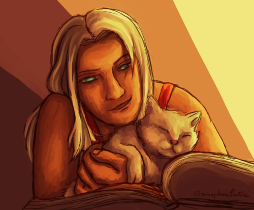 Elma all warm and happy with her cat and book friend.