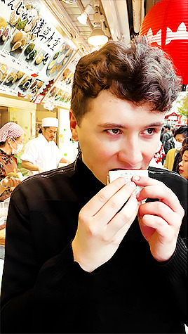 danielhowall: photo of a human actively transcending eating an ‘agemanju’ deep-fried cake vs photo o